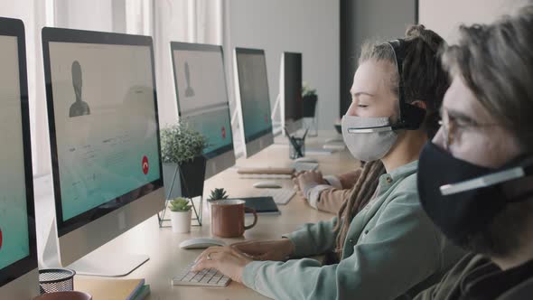 People in Face Masks Working in Call Center