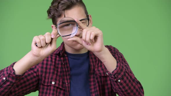 Young Handsome Teenage Nerd Boy Playing with Magnifying Glass