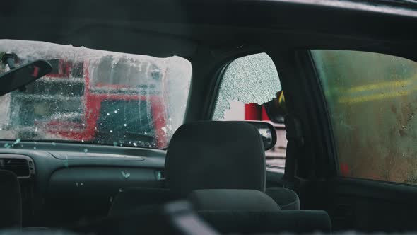 Car Accident Rescue, Firefighter Breaking the Glass on the Car Door. Close Up, Slow Motion Shot