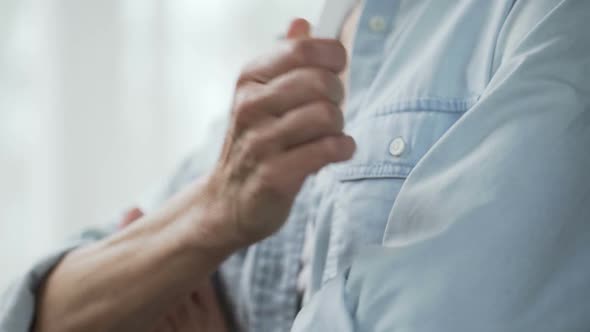 Lady Crossing Hands Holding Positive Pregnancy Test and Making Decision