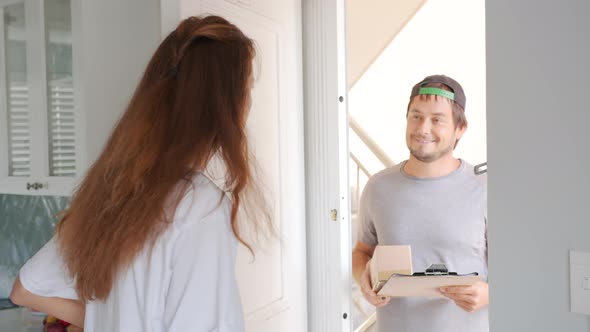Close Up Woman Receive a Cardboard Box From a Delivery Man