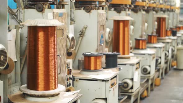 Copper Wire Winding on Coils at Factory. Bronze Cable Rolling on Reels at Plant