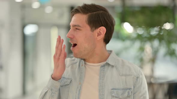 Portrait of Sleepy Creative Young Man Yawning