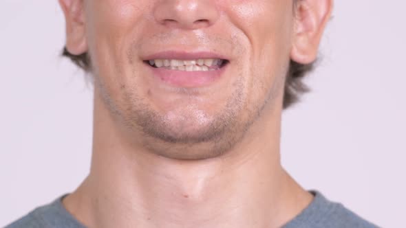 Closeup of Mouth of Happy Man Smiling Against White Background