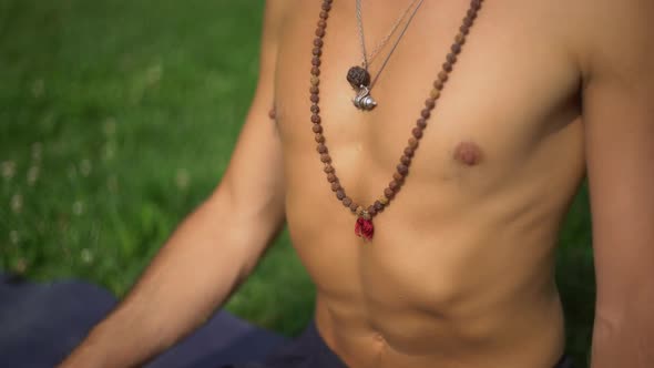 A Man in a Lotus Position Meditating in the Park