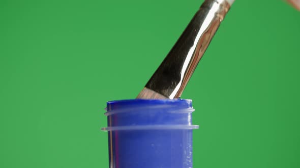 Blue Paint Isolated on Green Background alt