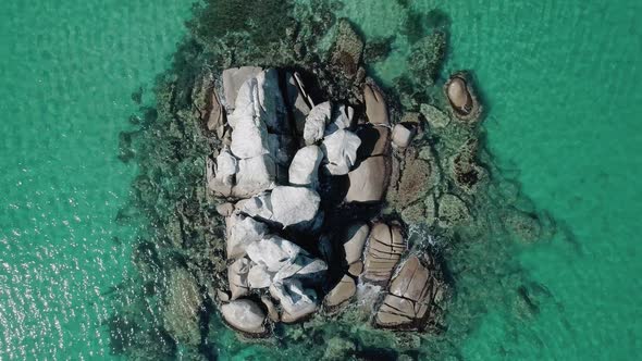 Aerial Top Down View of Huge Rocks in the Sea and Turquoise Water
