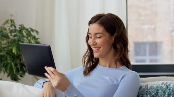 Woman Having Video Call on Tablet Pc at Home