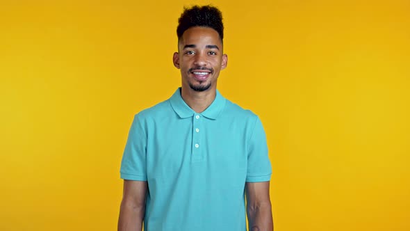 Portrait of Smiling African American Handsome Man in Blue Looking To Camera. Guy in Studio on Bright