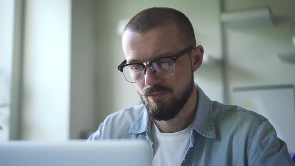 Young Man Freelancer Using Laptop Studying Online Working in Internet. Focused Millennial Guy Spbd