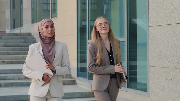 Confident Smiling Diverse Colleagues Indian Girl in Hijab and Young Caucasian Slavs Woman in Formal