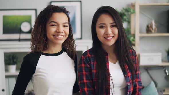 Slow Motion Portrait of Good-looking Girls Mixed-race Friends African American and Asian Looking at