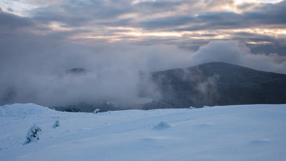 Moving mists over the snow-covered mountain slopes