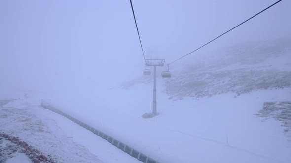 Empty Chairlift in a Ski Resort on a Foggy Cloudy Day