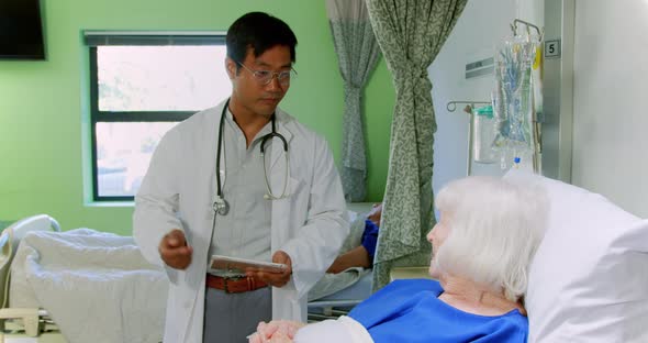 Male doctor interacting with senior patient 4k