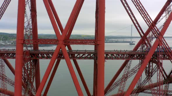 A Train Crossing a Red Bridge in Scotland