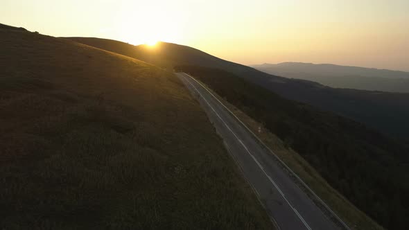 Road Cycling on a Mountain Pass at Sunset