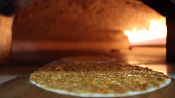 Cooking pizza in fired oven. Close up view.	