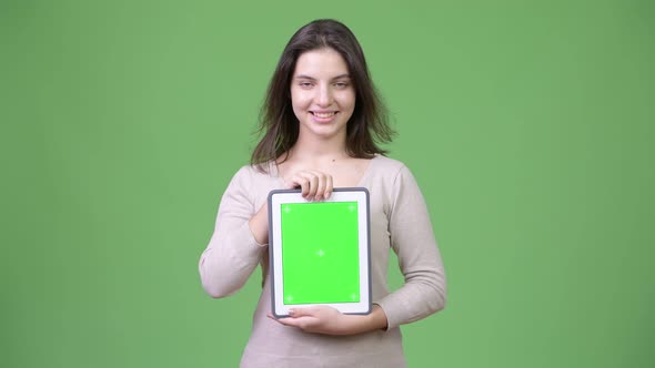 Young Happy Beautiful Woman Smiling While Showing Digital Tablet