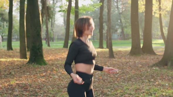 Athletic Woman Using Jumping Rope for Training Outdoors