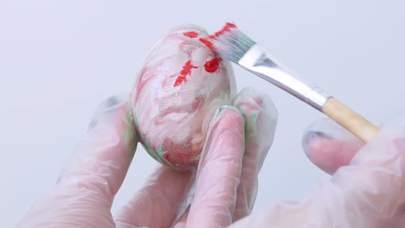 Closeup of a Person Painting Easter Eggs with a Special Brush