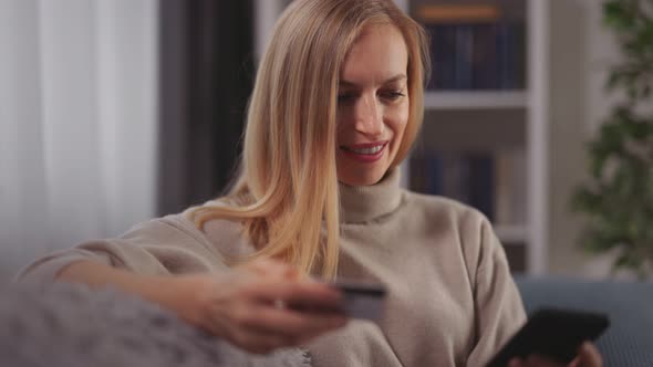 Woman Using Credit Card and Mobile