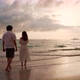 Young asian couple looking beautiful sunset on the tranquil beach - VideoHive Item for Sale