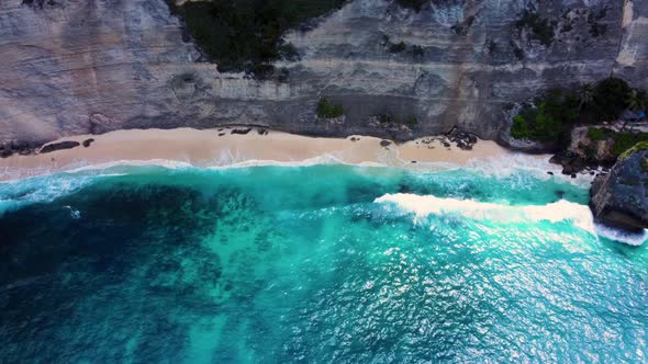 View on Sandy Beach Under Cliff with Azure Water