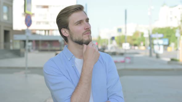 Portrait of Pensive Man Thinking Outdoor