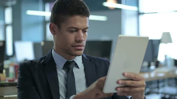 Portrait of African Businessman Using Tablet in Office