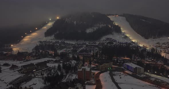 Aerial Forward Mountain Popular Ski Resort Cityscape Modern Houses Among Dark Mountains Tourist