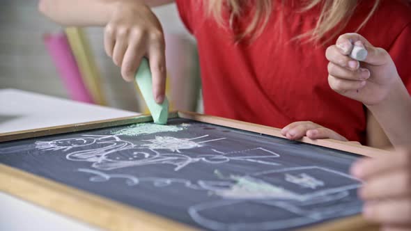 Children Drawing with Chalk on Blackboard