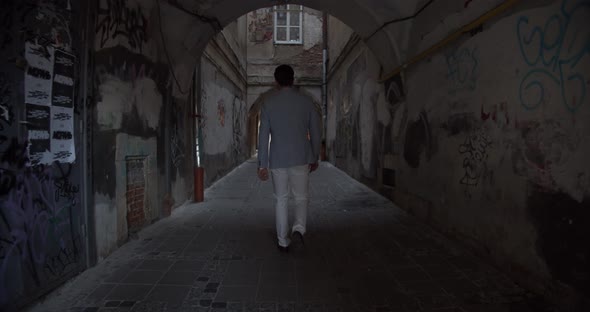 A Man Walks Through The Arch Of The Old City