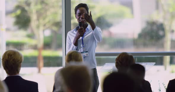 female speaker speaks in a business seminar at modern office 4k