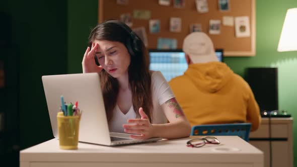 Stressed Businesswoman Working Late at Night in the Office While Her Colleague Left Home