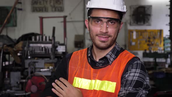 Caucasian male worker putting on hard hat and goggles, and smiling