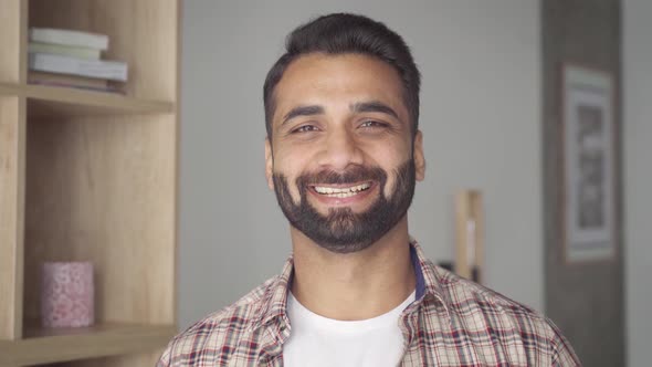 Headshot Portrait of Smiling Attractive Indian Businessman Indoors