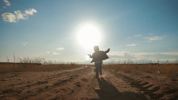 Young Family Playing in the Field with Soccer Ball at Sunset. Concept of Friendly Family.