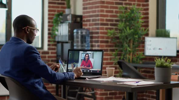 African American Worker Meeting with Businesswoman on Online Video Call