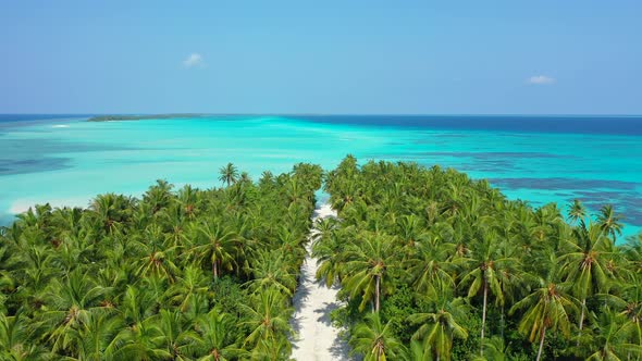 Daytime birds eye abstract shot of a paradise sunny white sand beach and aqua blue water background 