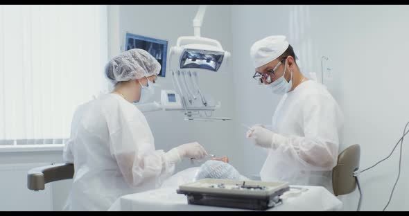 The Patient Lies on the Dental Chair During Treatment