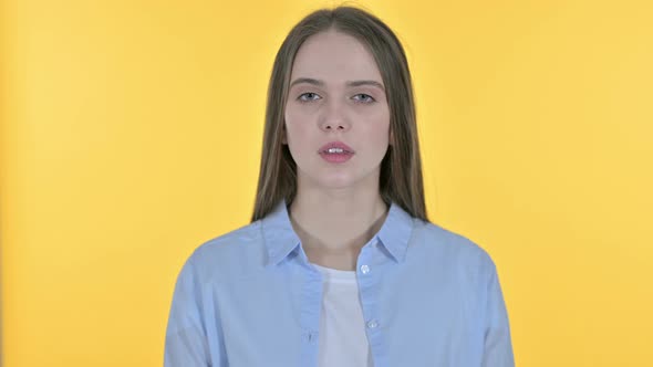 Casual Young Woman Saying No By Head Shake, Yellow Background