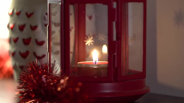 Lit Candle in a Red Christmas Lantern - Closeup