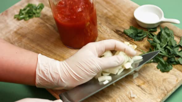 Pouring diced tomatoes from an open can into hand blender glass. Process of making salsa