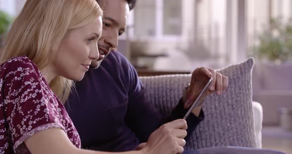 Couple Have Relax on Couch in Living Room with Tablet