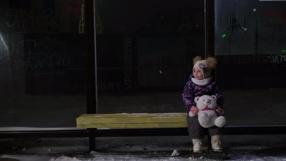 Girl Alone at the Bus Stop Waiting for the Bus