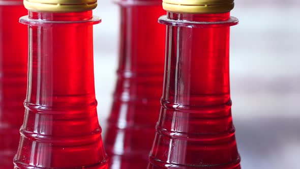 Plastic Bottles of Red Color Drink on Table