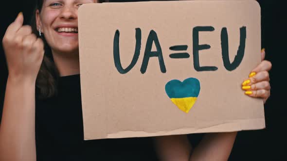 Girl Holds Poster and Rejoices That Ukraine is a Candidate of the European Union