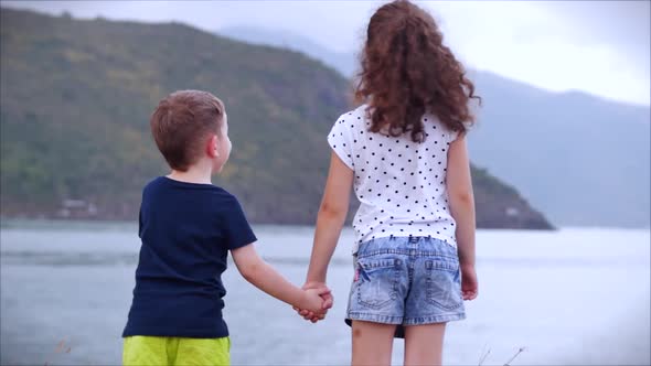 Happy Family Kids Boy and Girl Holding Hands Holding Hands Children Watching the Sea at Sunset Ocean