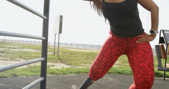 Disabled woman exercising in the park on sunny day 4k